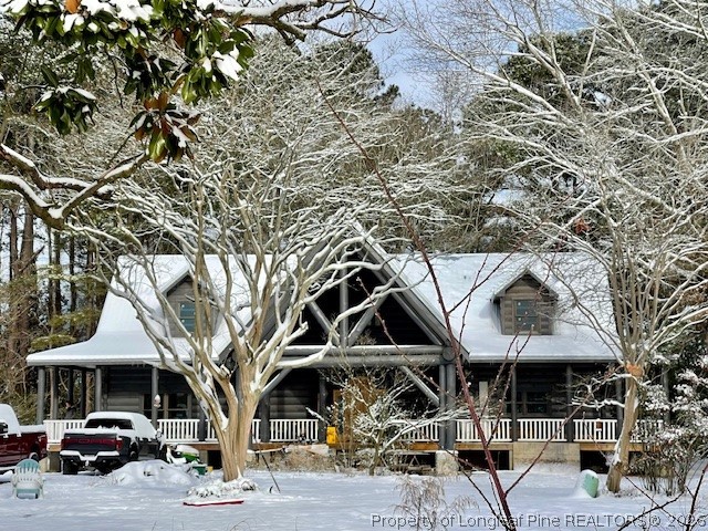 a front view of a building with streets and trees