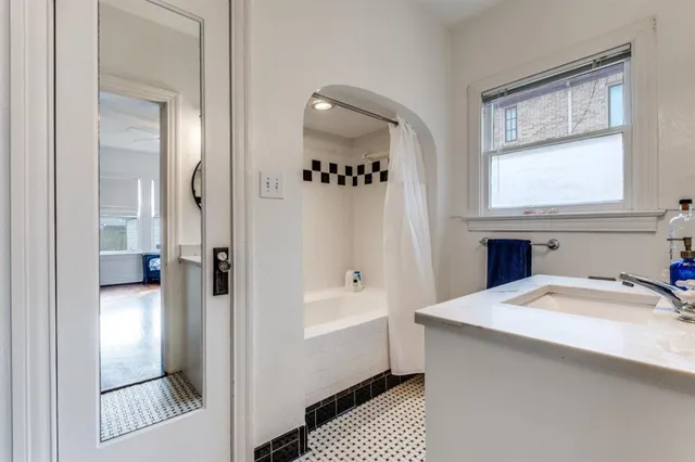 a bathroom with a sink a mirror and a bathtub