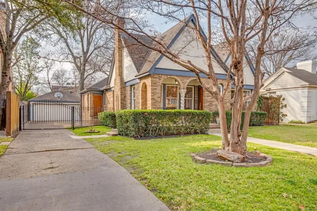 a front view of a house with a yard garage and fountain