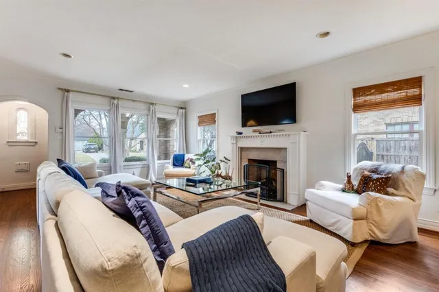 a living room with fireplace furniture and a flat screen tv