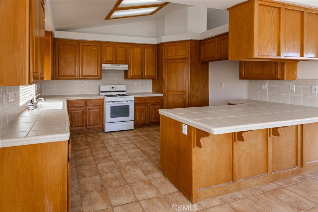 12384 Redwood Road Pinon Hills, CA 92372 - Photo 11 of 35 a kitchen with stainless steel appliances granite countertop a sink counter space and cabinets