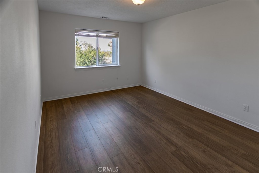 12384 Redwood Road Pinon Hills, CA 92372 - Photo 17 of 35 an empty room with wooden floor and windows