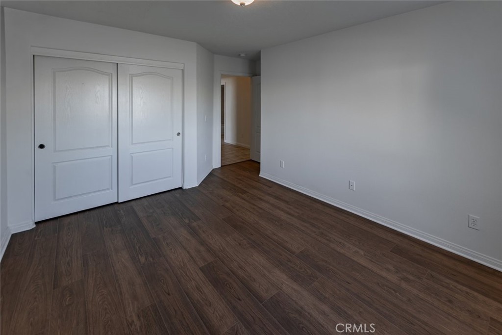 12384 Redwood Road Pinon Hills, CA 92372 - Photo 18 of 35 a view of an empty room with wooden floor