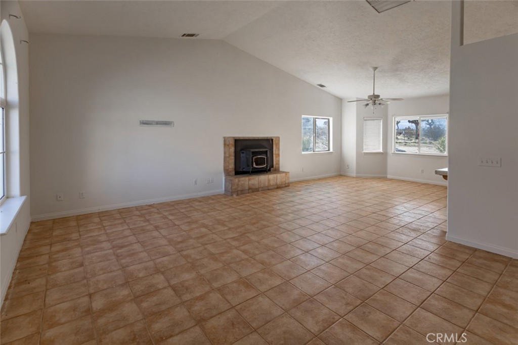 12384 Redwood Road Pinon Hills, CA 92372 - Photo 7 of 35 an empty room with windows and fireplace