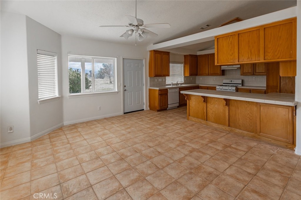 12384 Redwood Road Pinon Hills, CA 92372 - Photo 10 of 35 a large kitchen with cabinets a sink and stainless steel appliances