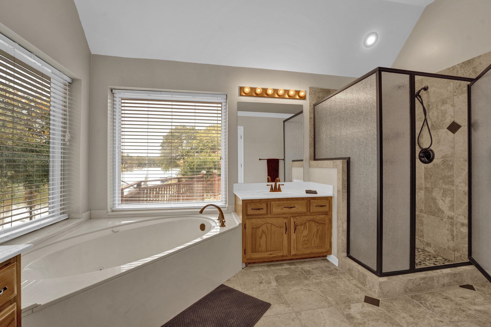 4077 Cedar Point Road Lakeland, TN 38002 - Photo 13 of 25 a spacious bathroom with a tub sink shower and mirror