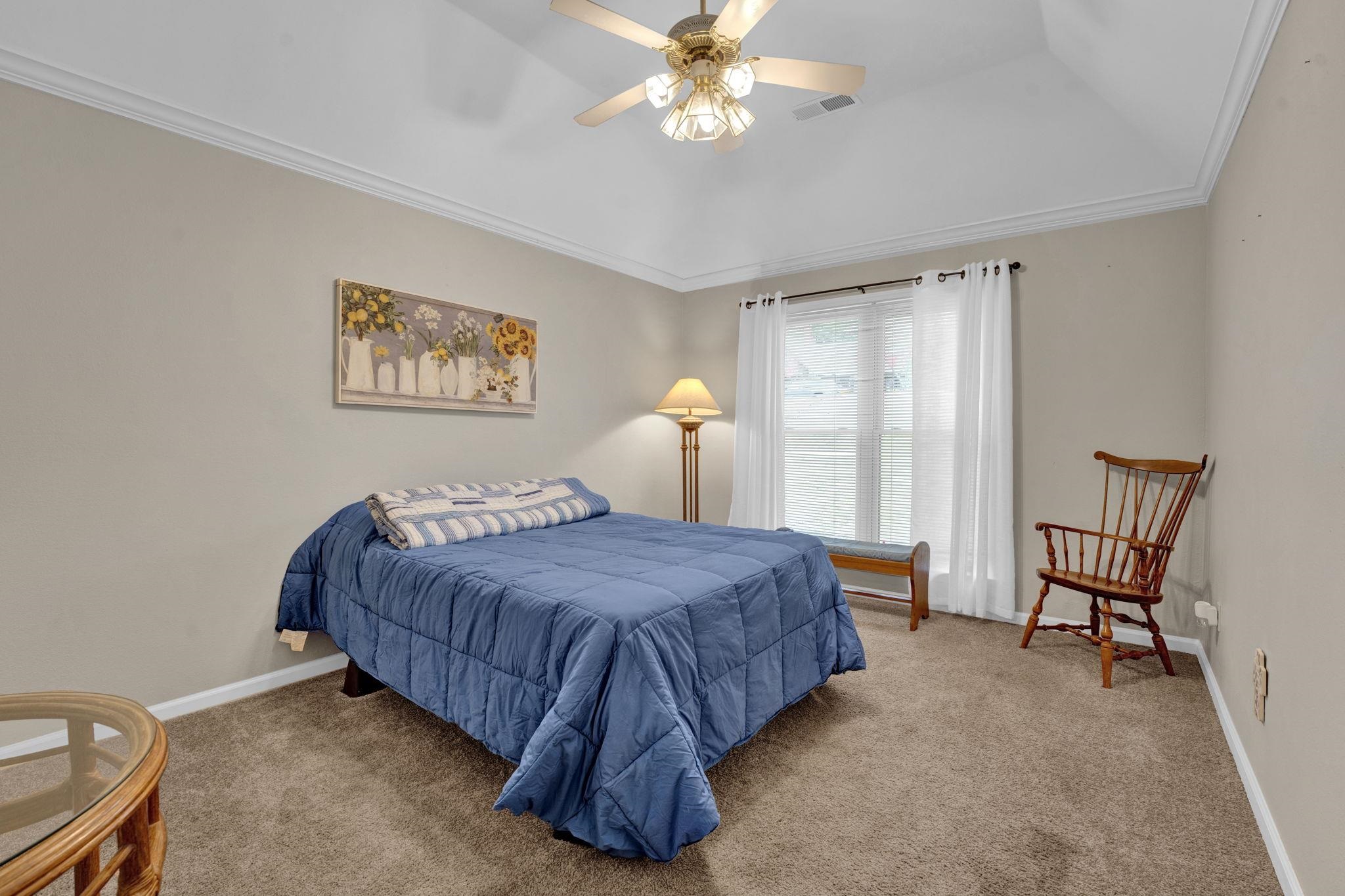4077 Cedar Point Road Lakeland, TN 38002 - Photo 15 of 25 a bedroom with a bed and a chandelier