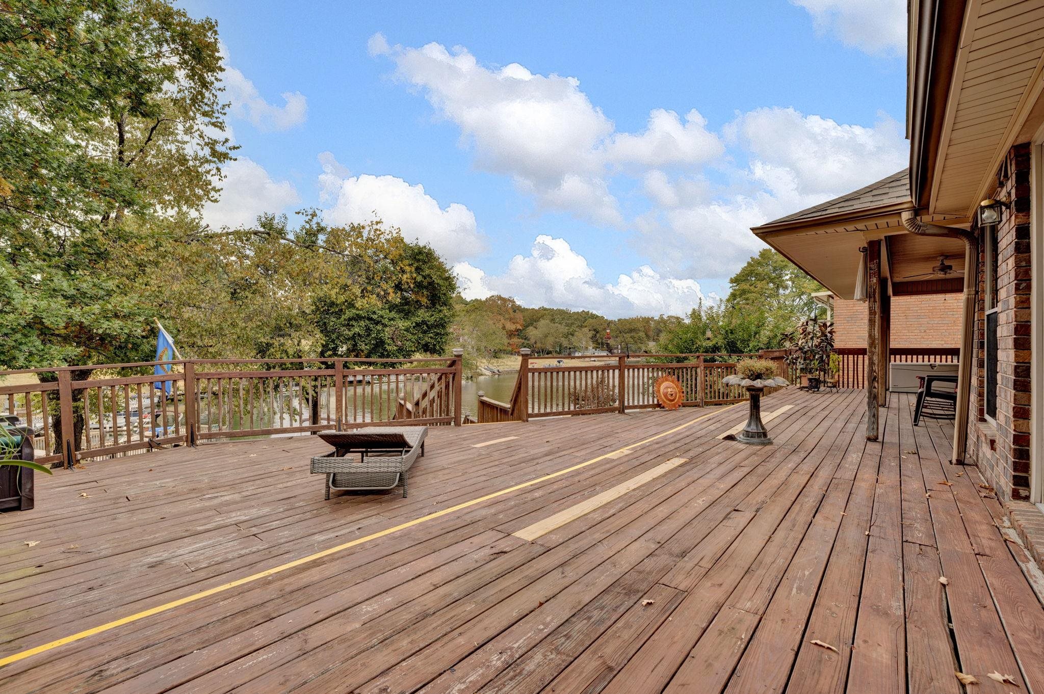4077 Cedar Point Road Lakeland, TN 38002 - Photo 18 of 25 a view of a roof deck with table and chairs a barbeque with wooden floor and fence