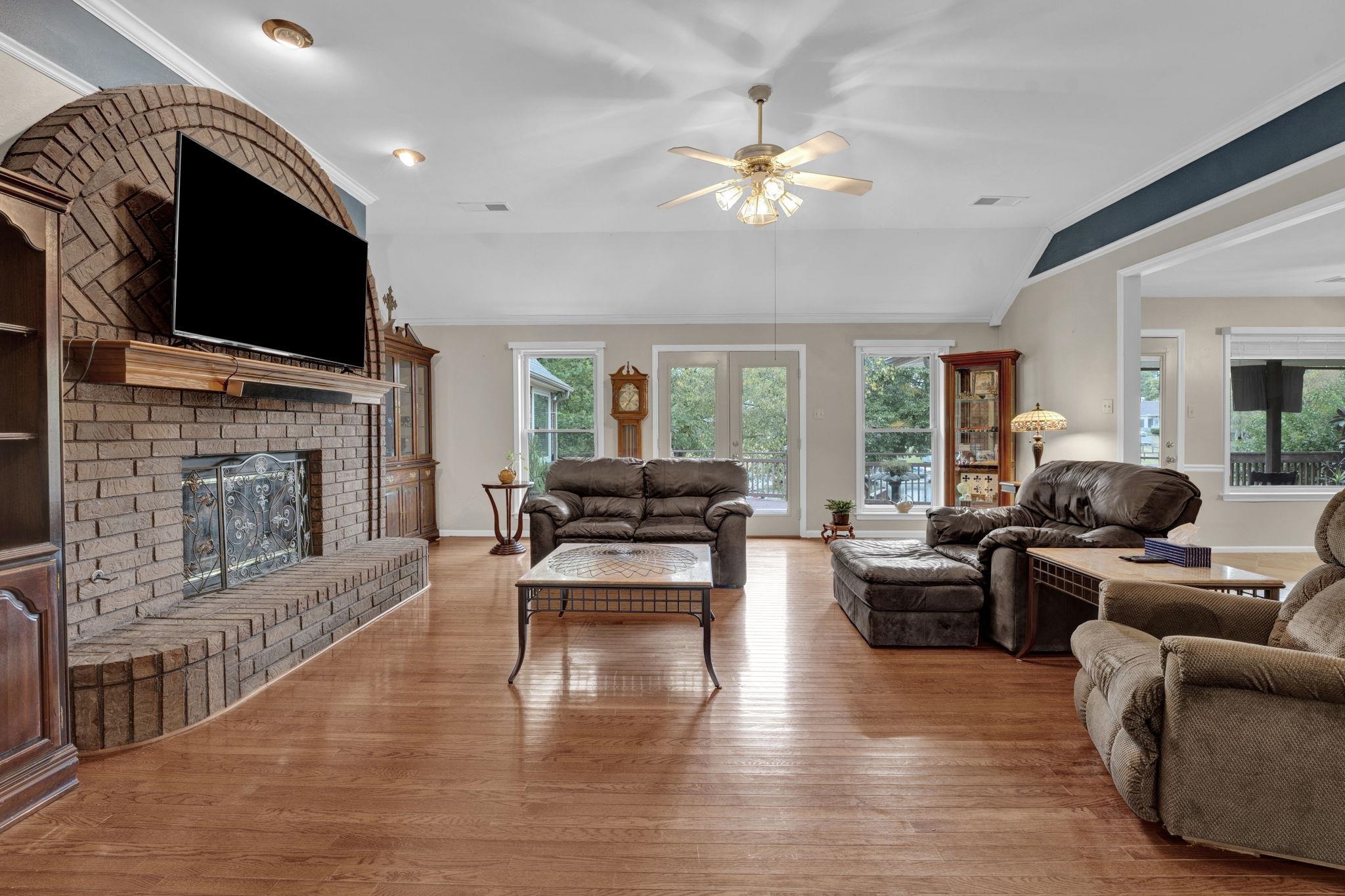4077 Cedar Point Road Lakeland, TN 38002 - Photo 2 of 25 a living room with fireplace furniture and a flat screen tv