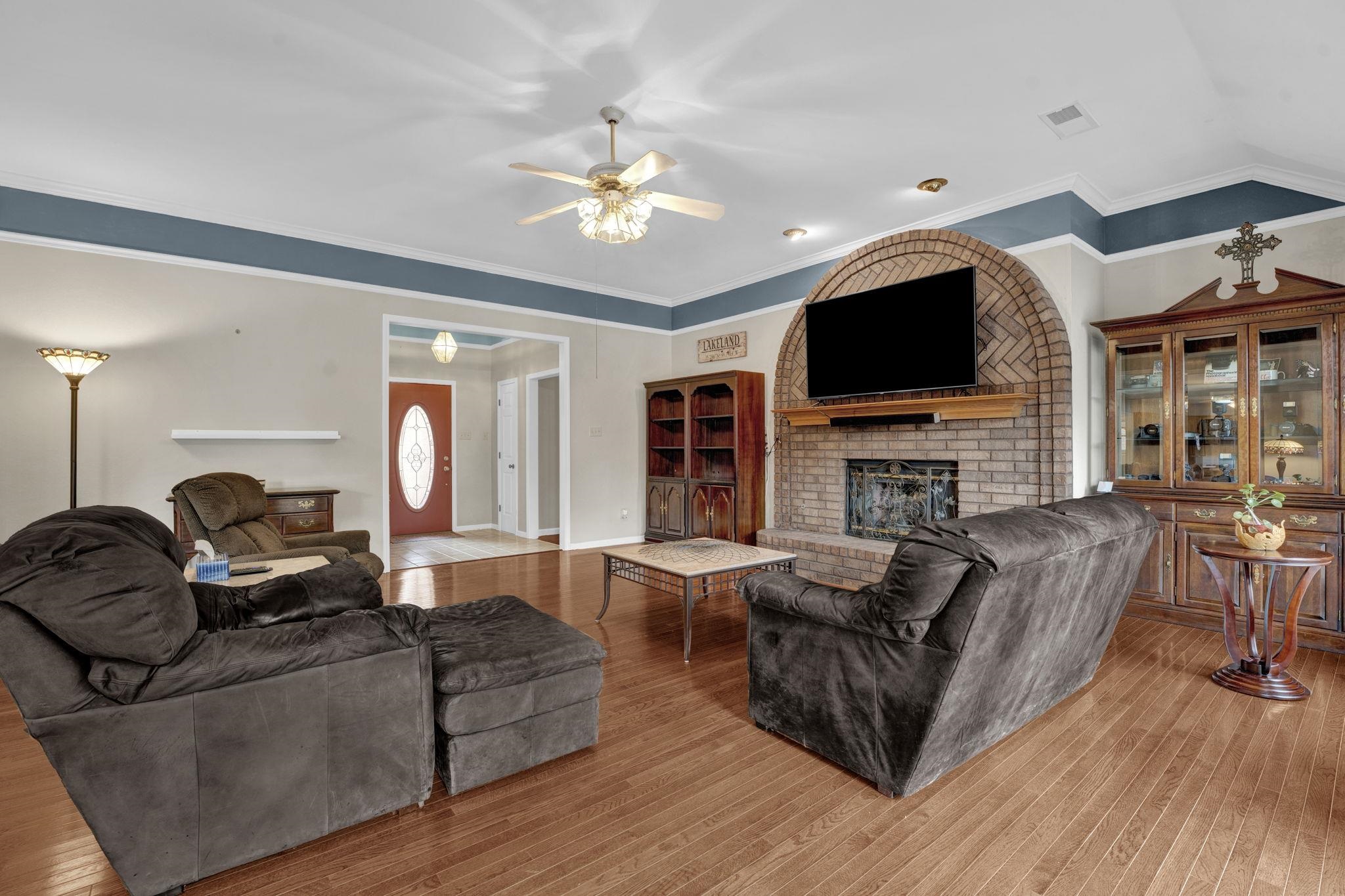 4077 Cedar Point Road Lakeland, TN 38002 - Photo 3 of 25 a living room with fireplace furniture and a flat screen tv