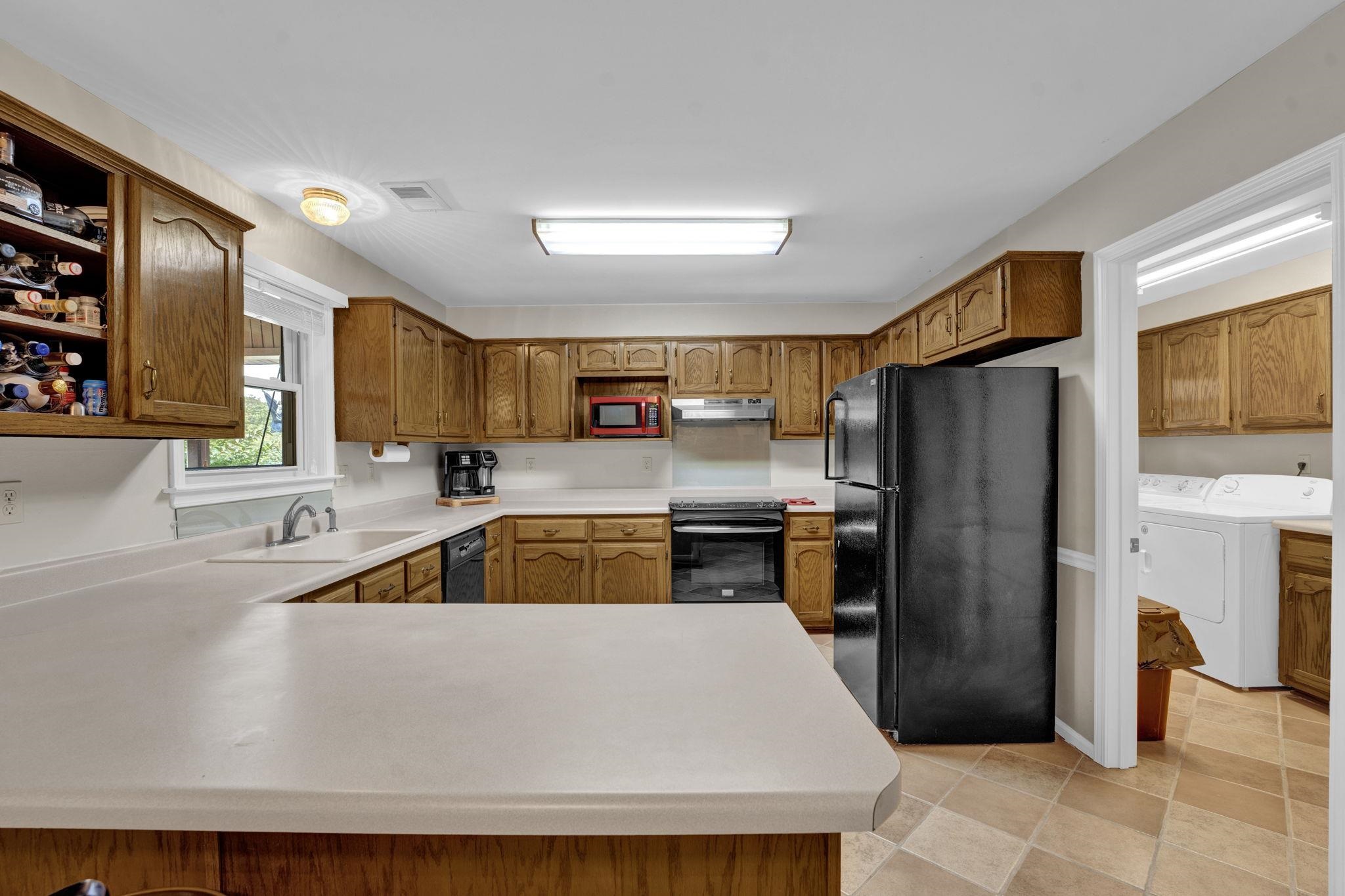 4077 Cedar Point Road Lakeland, TN 38002 - Photo 6 of 25 a kitchen with granite countertop a refrigerator and a sink