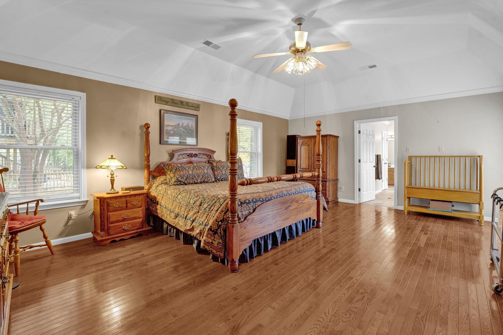 4077 Cedar Point Road Lakeland, TN 38002 - Photo 10 of 25 a spacious bedroom with a bed and a chandelier