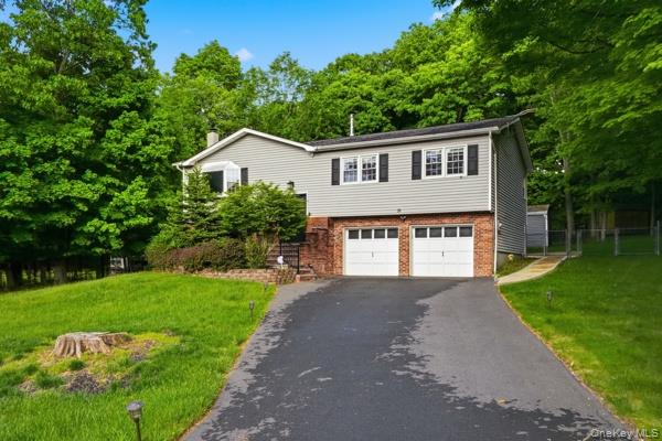 31 Laura Road Monroe, NY 10950 - Photo 2 of 39 a front view of a house with a yard and garage