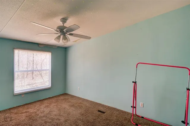 a view of a room with a fan and a window