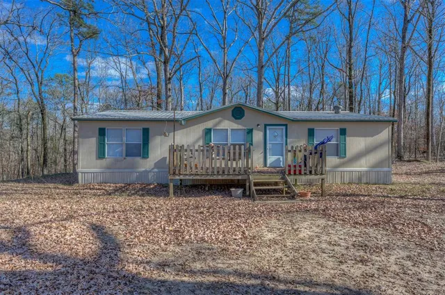 a small house in middle of a yard
