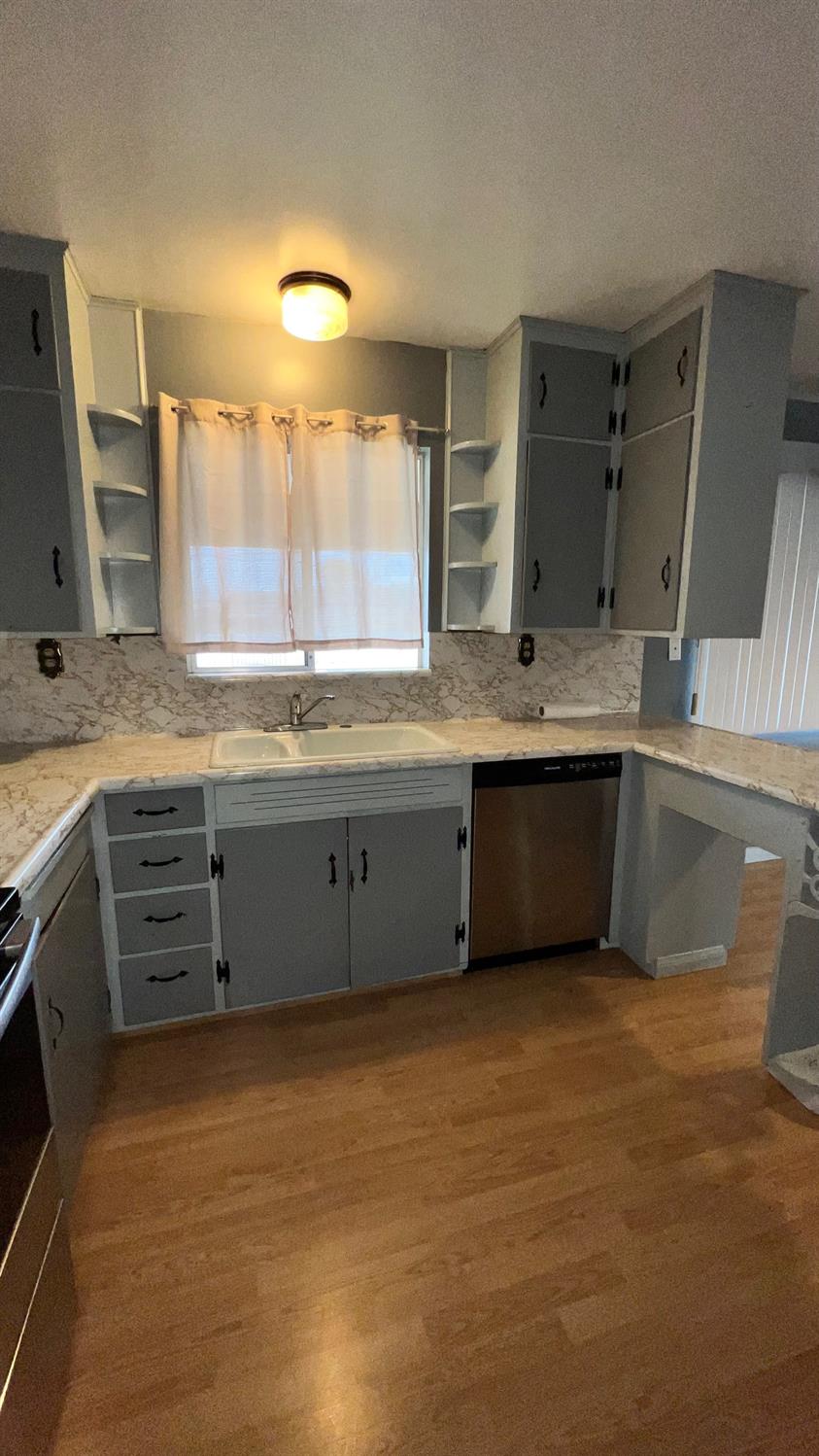 56 West Hanford Armona Road Lemoore, CA 93245 - Photo 12 of 15 a large kitchen with a sink and a large window