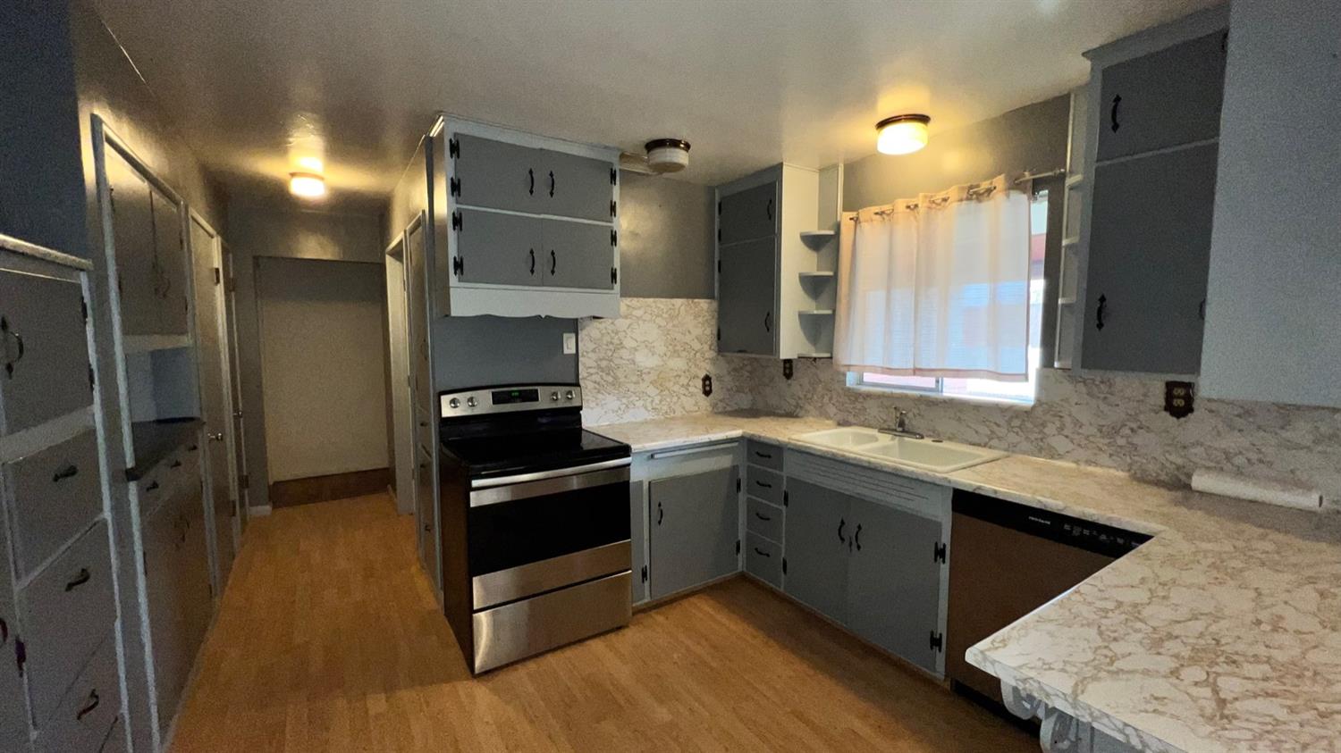 56 West Hanford Armona Road Lemoore, CA 93245 - Photo 15 of 15 a kitchen with a sink and stainless steel appliances
