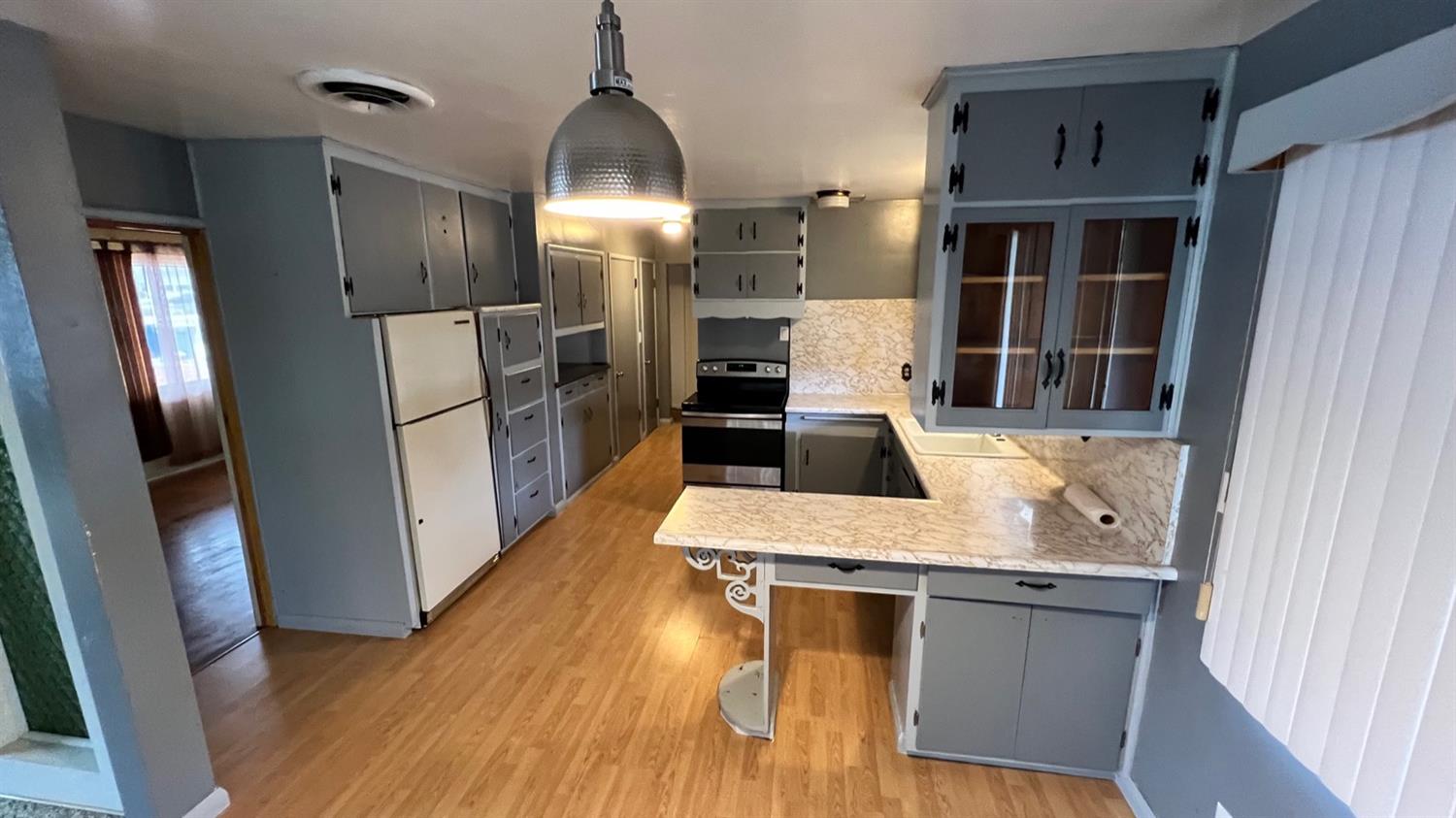 56 West Hanford Armona Road Lemoore, CA 93245 - Photo 2 of 15 a kitchen with stainless steel appliances granite countertop a refrigerator a stove and a sink