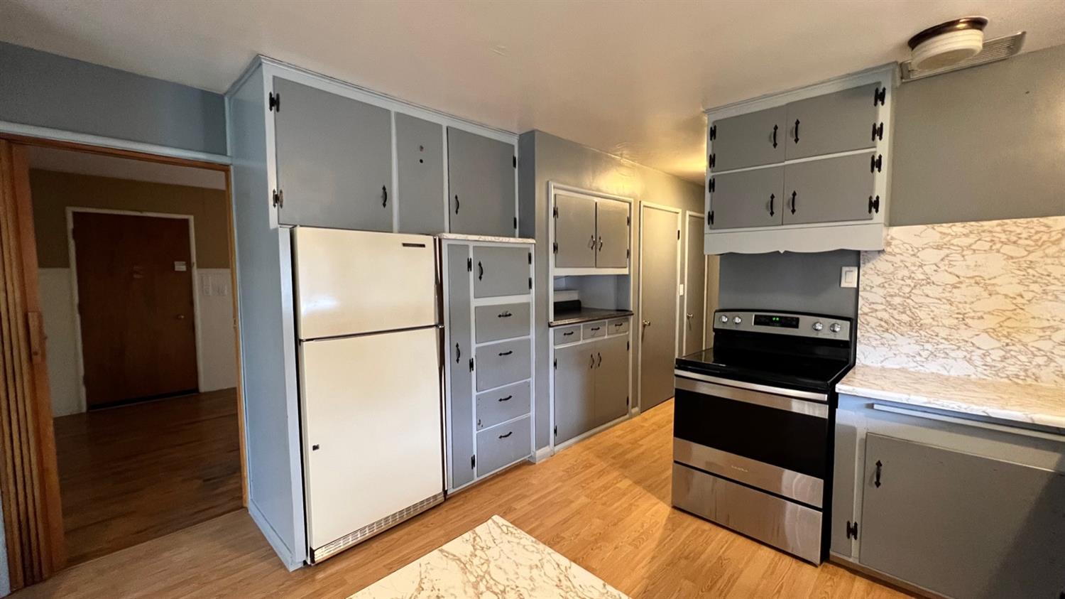 56 West Hanford Armona Road Lemoore, CA 93245 - Photo 4 of 15 a kitchen with granite countertop a refrigerator and a stove