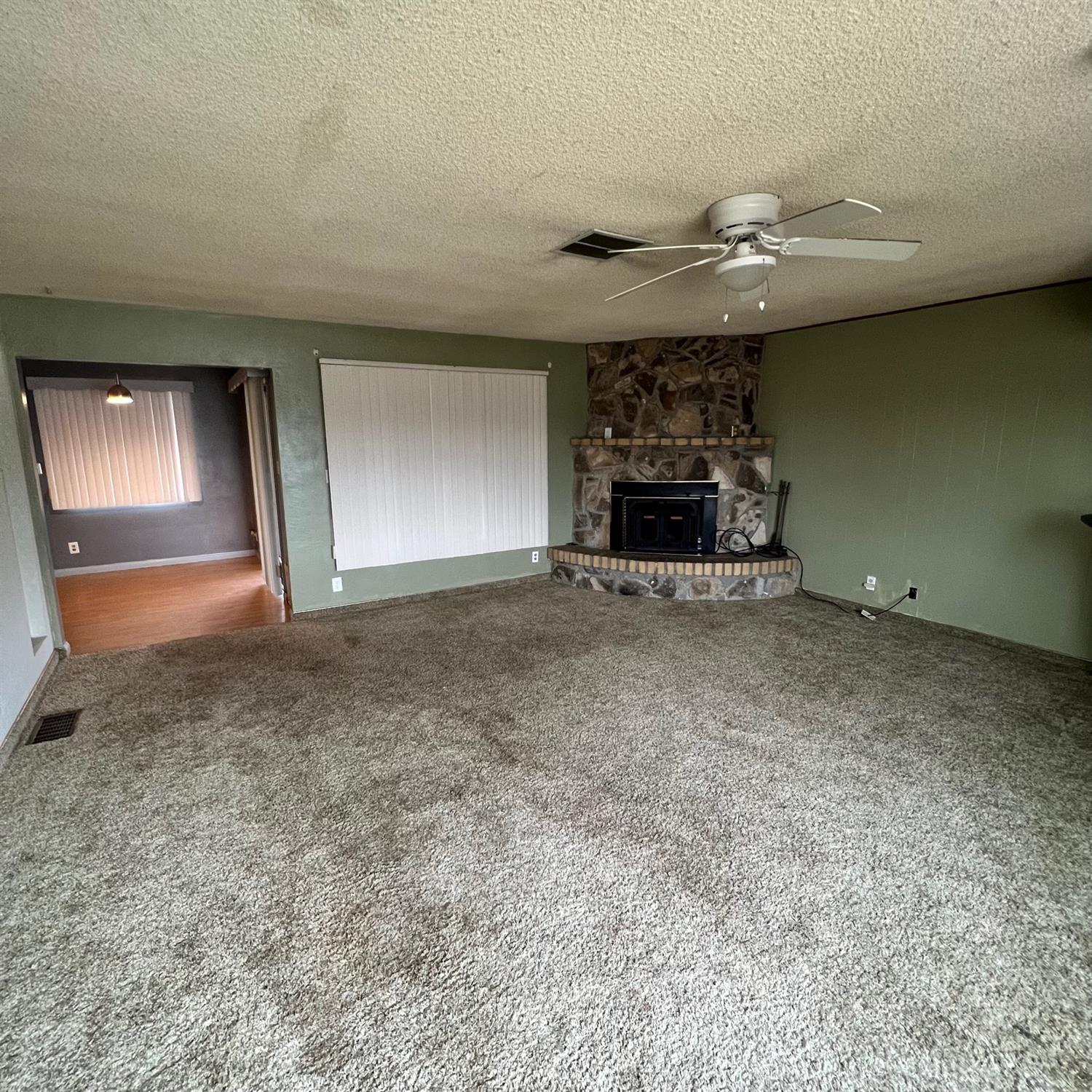 56 West Hanford Armona Road Lemoore, CA 93245 - Photo 7 of 15 an empty room with fire place and fireplace