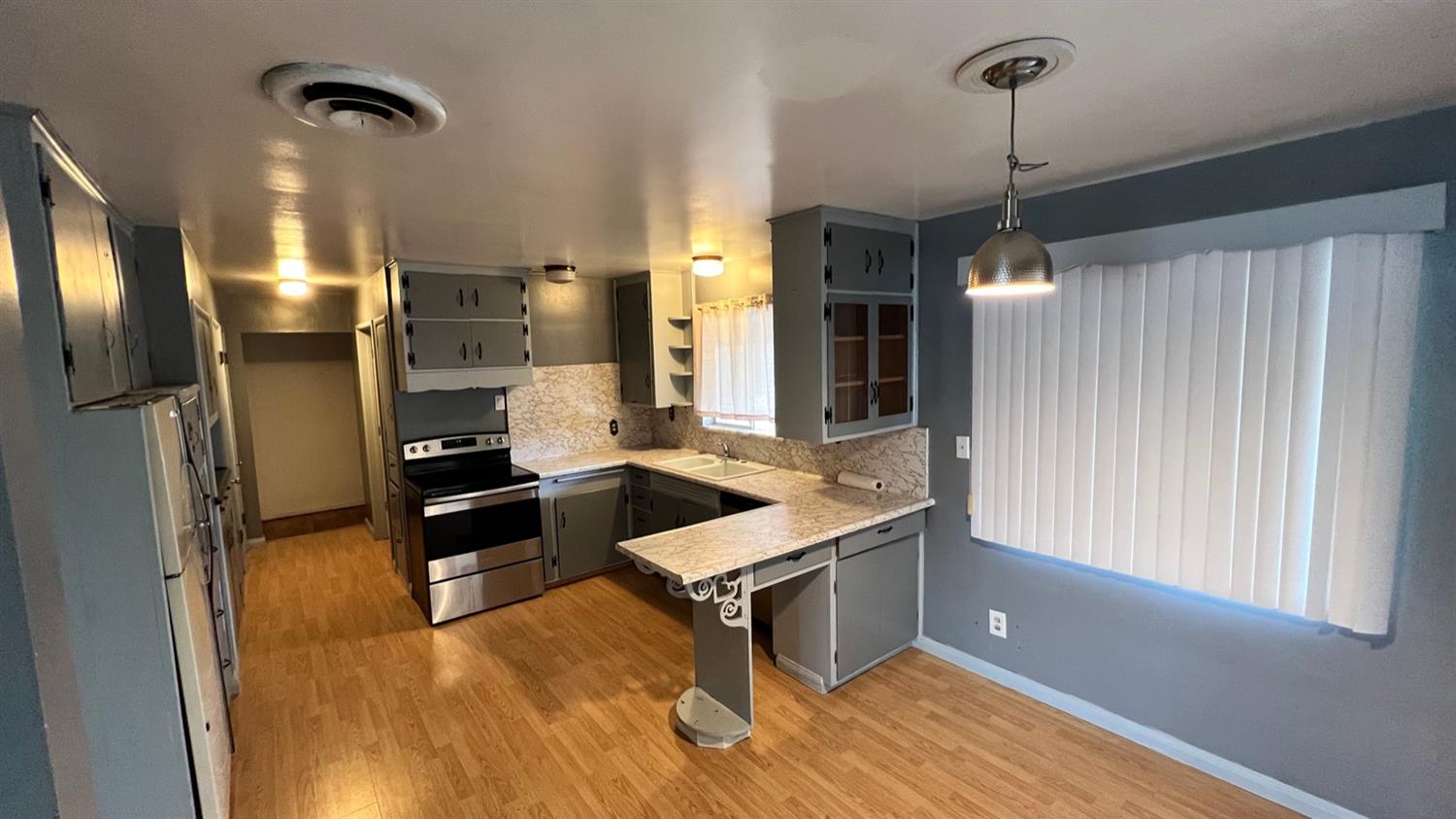 56 West Hanford Armona Road Lemoore, CA 93245 - Photo 8 of 15 a kitchen with stainless steel appliances granite countertop a refrigerator a oven and a sink with granite countertops