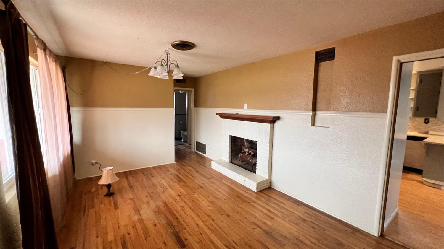 56 West Hanford Armona Road Lemoore, CA 93245 - Photo 9 of 15 a view of empty room with wooden floor and fireplace