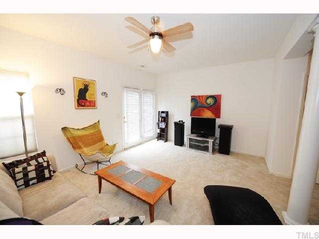 506 Erie Road Raleigh, NC 27610 - Photo 4 of 7 a living room with furniture and a flat screen tv