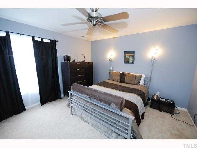 506 Erie Road Raleigh, NC 27610 - Photo 5 of 7 a bedroom with a bed and a walk in closet