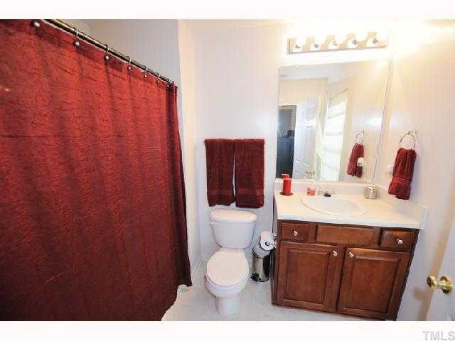 506 Erie Road Raleigh, NC 27610 - Photo 6 of 7 a bathroom with a sink a toilet and mirror