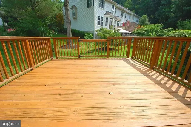 a view of a hallway with wooden floor and a window