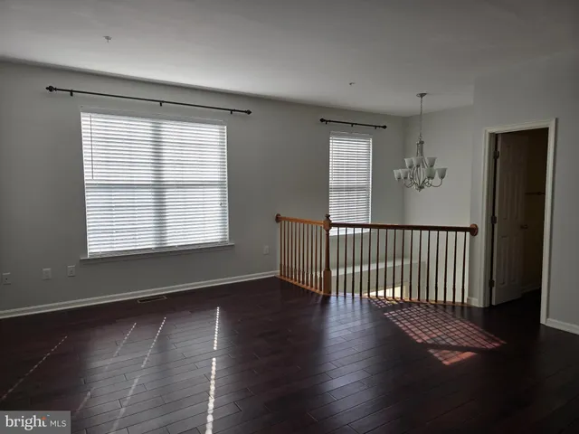 a view of a room with a window and a ceiling fan