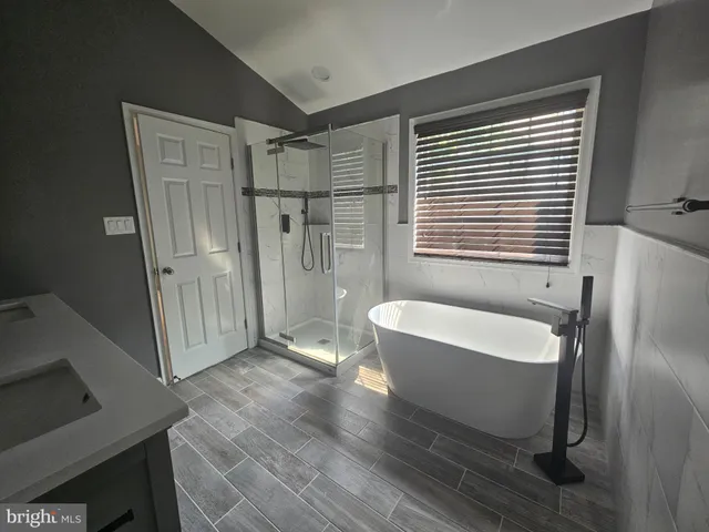 a spacious bathroom with a bathtub and shower