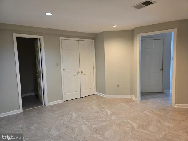 a view of a house with a wooden deck and a yard