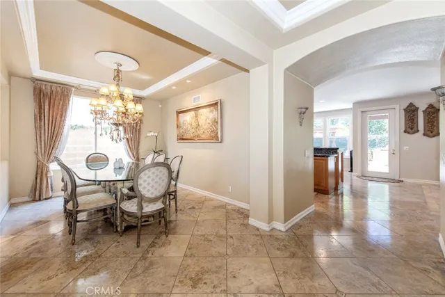 a view of a dining room with furniture and chandelier