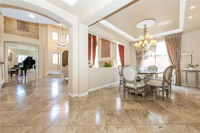 a kitchen with granite countertop a stove and white cabinets