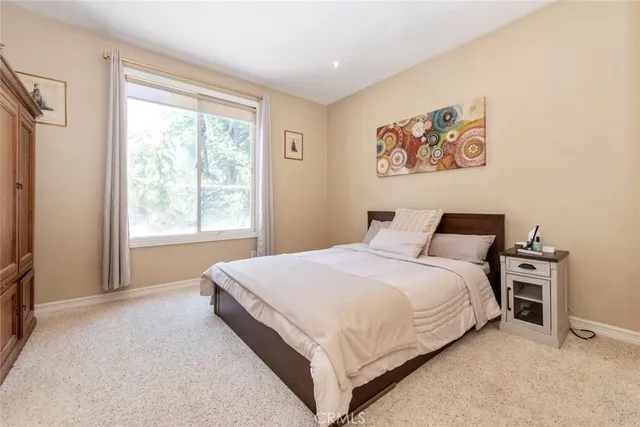 a bedroom with bed and a window