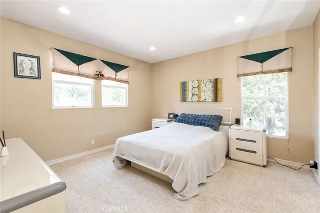 a view of a patio with table and chairs potted plants and large tree