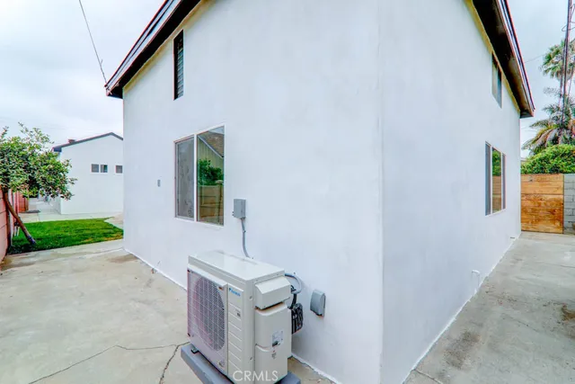 a kitchen with a refrigerator and a white wooden cabinets