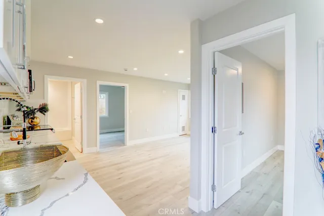 a kitchen with granite countertop a stove a microwave a sink and cabinets
