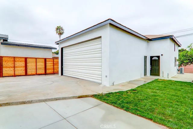 a view of an house with backyard space and garden