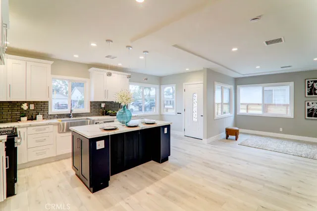 a kitchen with stainless steel appliances granite countertop a stove and a sink