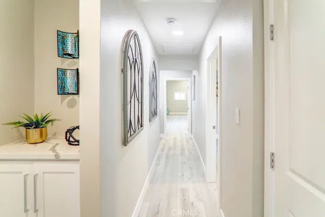 a view of a hallway with windows and entryway