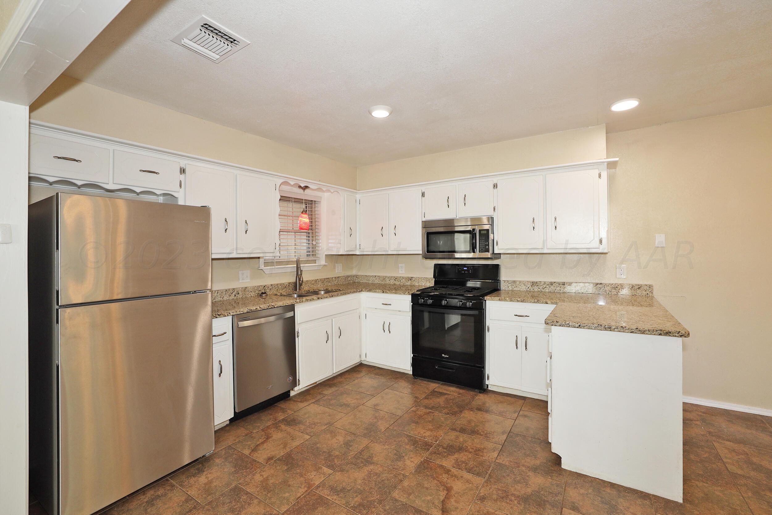 2905 Salem Drive Amarillo, TX 79110 - Photo 5 of 29 a kitchen with stainless steel appliances granite countertop a refrigerator stove sink and dishwasher