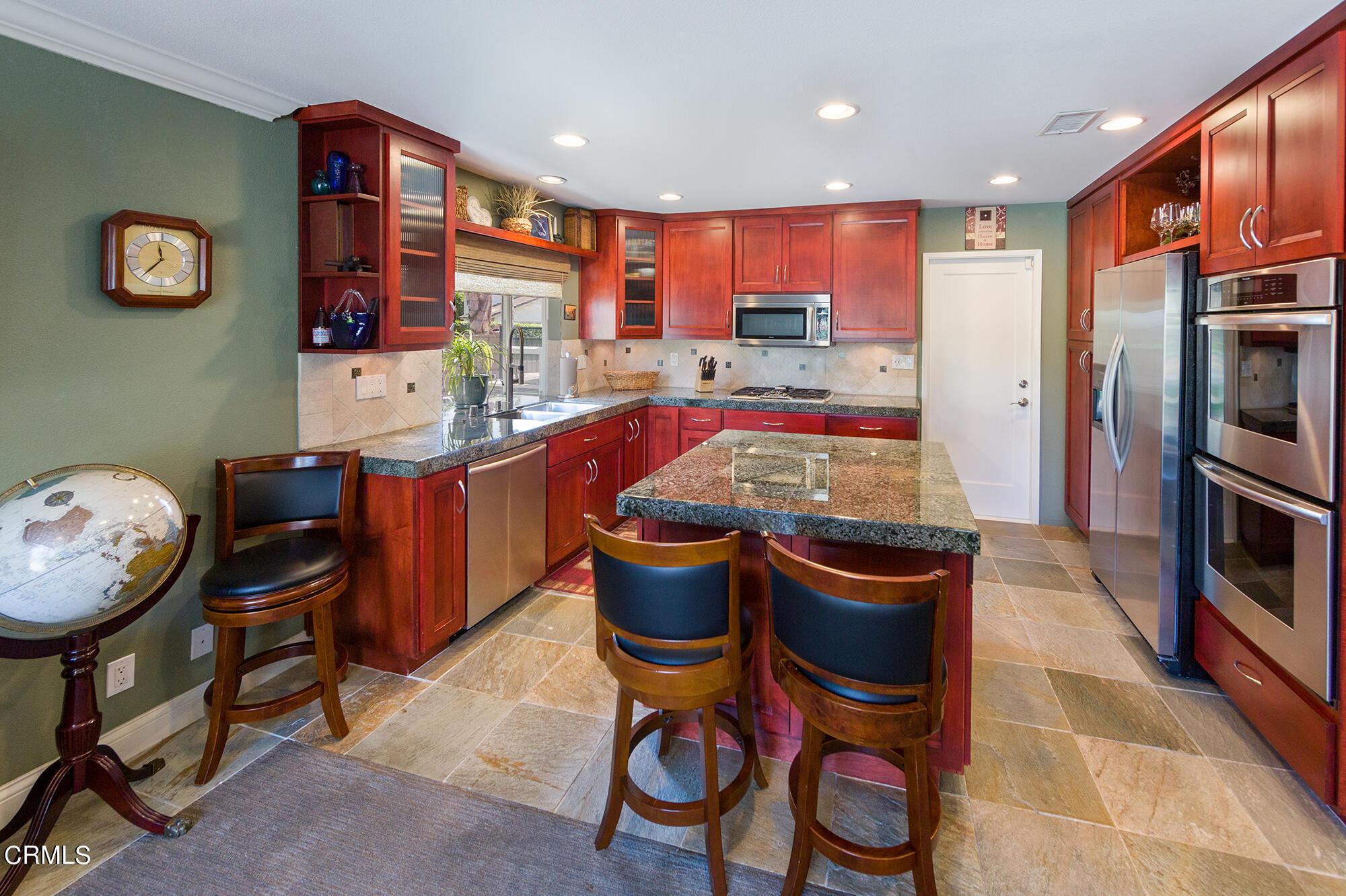777 Sir George Court Moorpark, CA 93021 - Photo 6 of 22 a kitchen with stainless steel appliances granite countertop a sink and a refrigerator