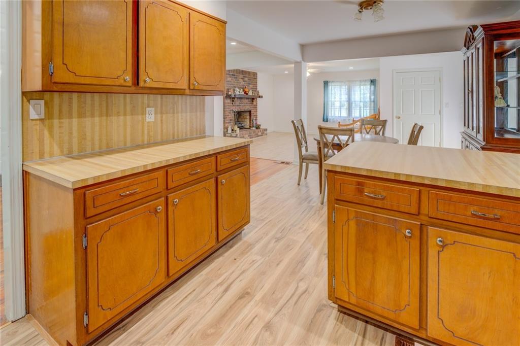 2194 Klondike Road Southwest Conyers, GA 30094 - Photo 13 of 30 a kitchen with stainless steel appliances granite countertop wooden cabinets a sink and a large window