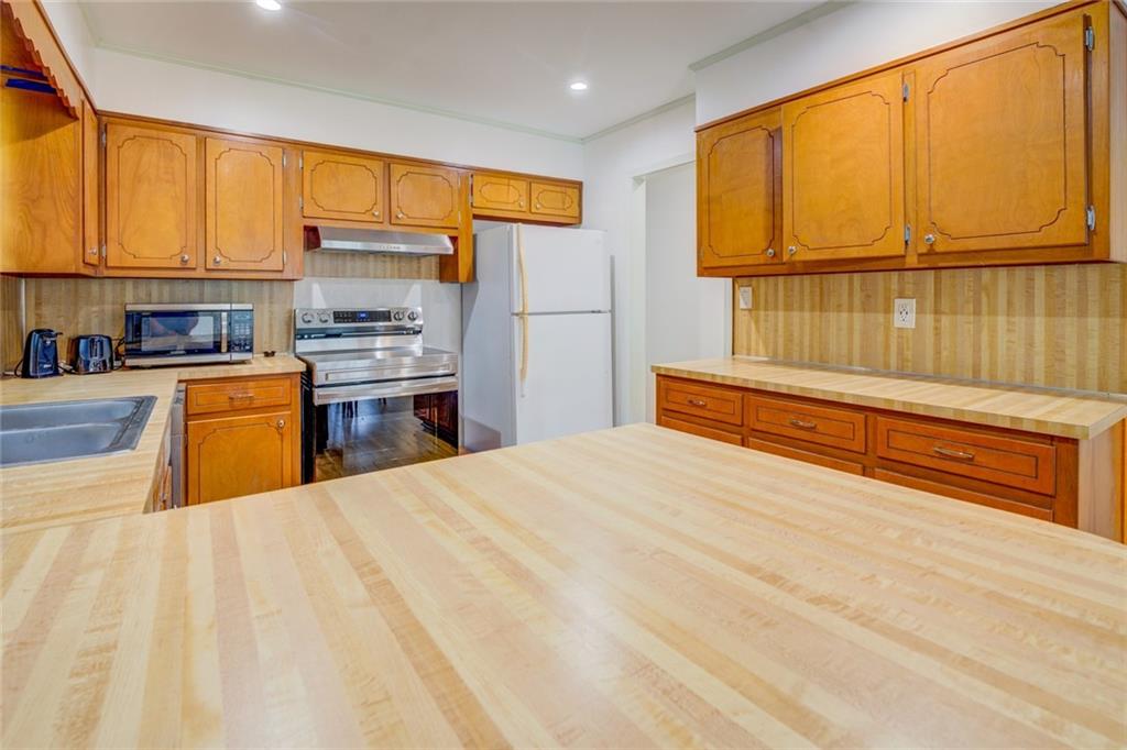 2194 Klondike Road Southwest Conyers, GA 30094 - Photo 14 of 30 a kitchen with stainless steel appliances granite countertop a refrigerator and cabinets