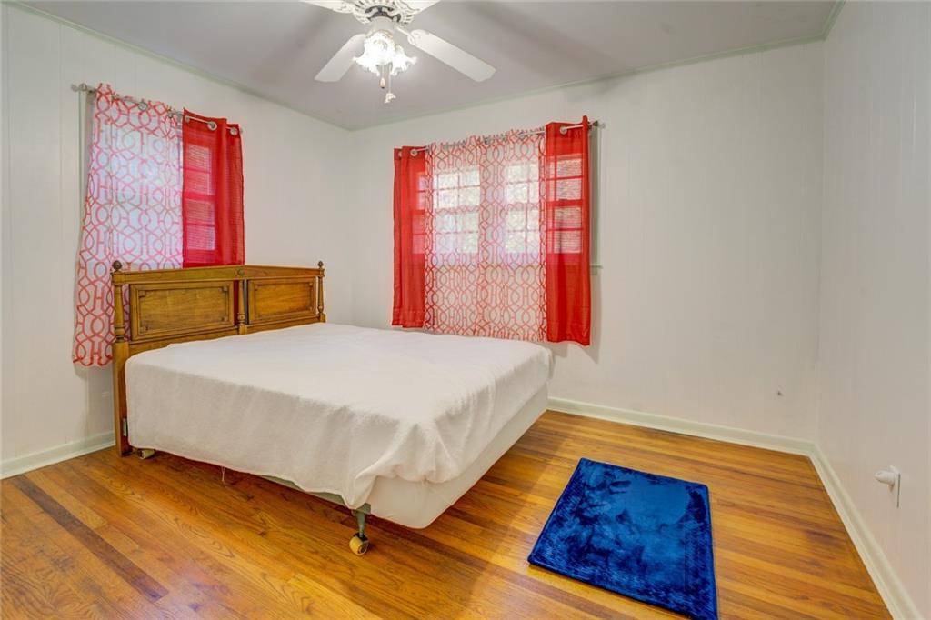 2194 Klondike Road Southwest Conyers, GA 30094 - Photo 18 of 30 a bedroom with a bed and wooden floor