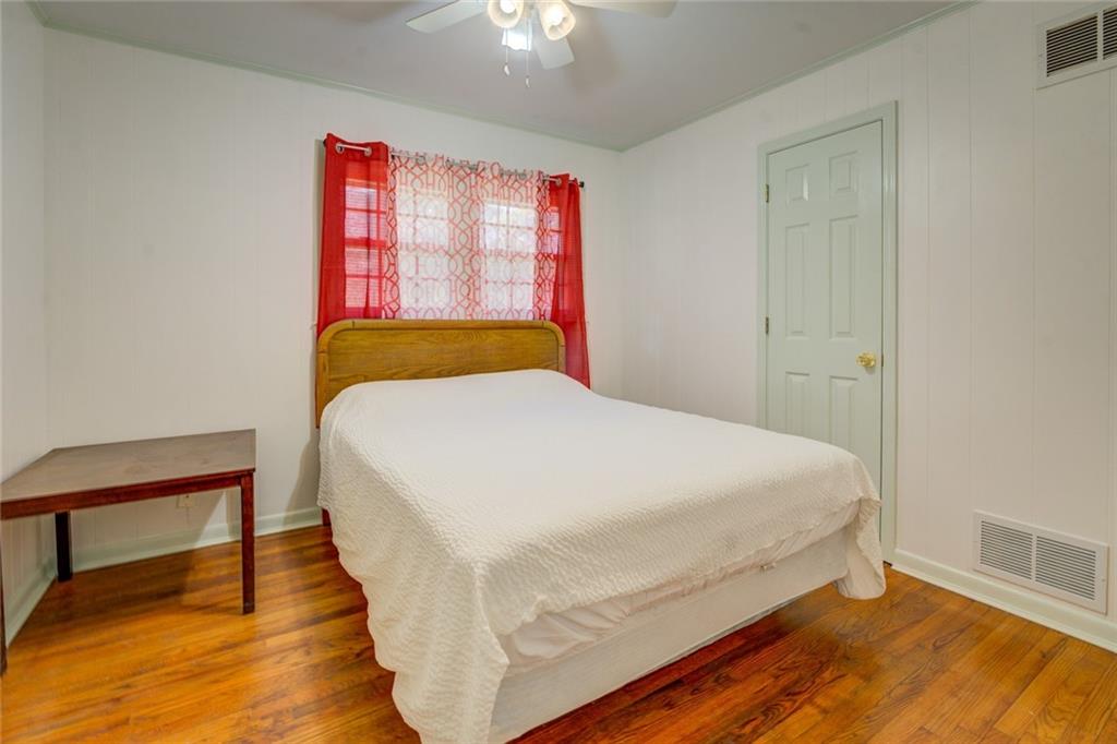 2194 Klondike Road Southwest Conyers, GA 30094 - Photo 19 of 30 a bedroom with a bed and wooden floor