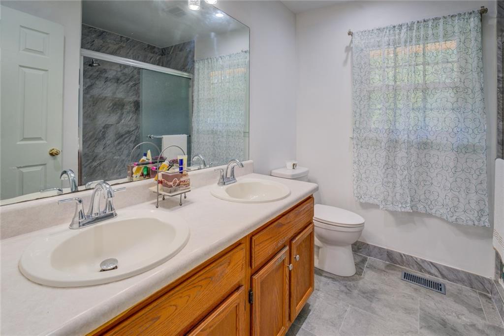 2194 Klondike Road Southwest Conyers, GA 30094 - Photo 20 of 30 a bathroom with a sink toilet and shower