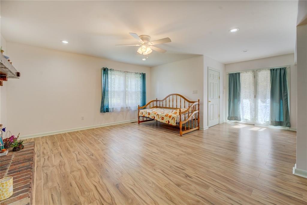 2194 Klondike Road Southwest Conyers, GA 30094 - Photo 3 of 30 a view of a livingroom with wooden staircase and a ceiling fan